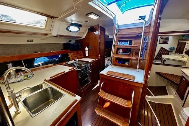 Slide: The Image of Interior of 1986 Hunter Passage 450 sailboat with kitchen and wooden finishes. - 42