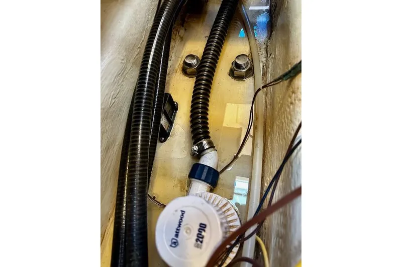 Slide: The Image of Bilge area of 1986 Hunter Passage 450 sailboat with hoses and wiring. - 44