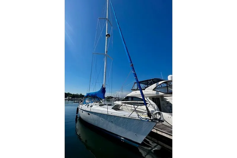 Slide: The Image of 1986 Hunter Passage 450 sailboat docked under clear blue sky. - 6