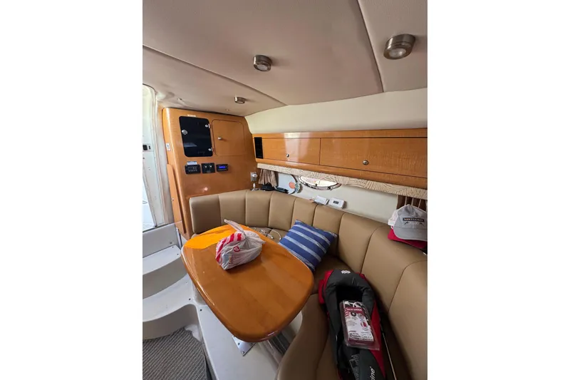 Slide: The Image of Interior of 2006 Chaparral Signature 310 yacht with cozy seating and wooden cabinetry. - 9