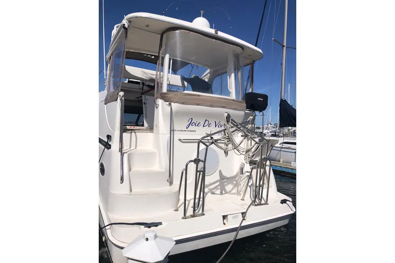 Slide: The Image of 2003 Silverton 35 Motor Yacht docked, featuring a spacious rear deck and elegant design. - 14