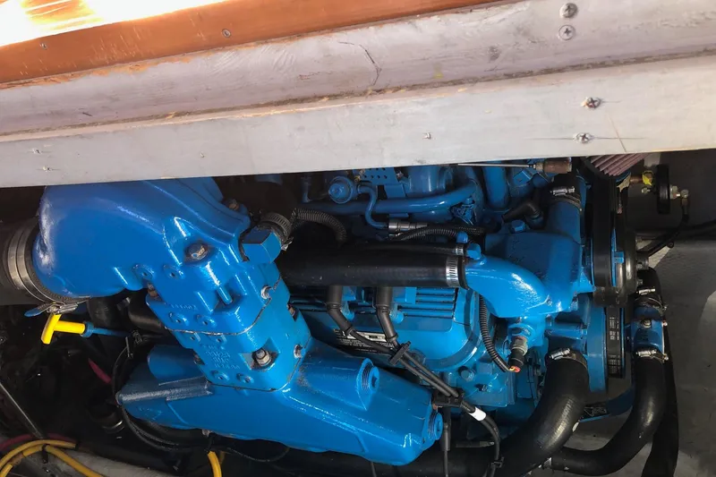 Slide: The Image of Engine compartment of a 2003 Silverton 35 Motor Yacht, featuring a blue engine. - 18