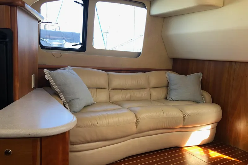 Slide: The Image of Luxurious interior of 2003 Silverton 35 Motor Yacht with beige leather sofa and wooden accents. - 2