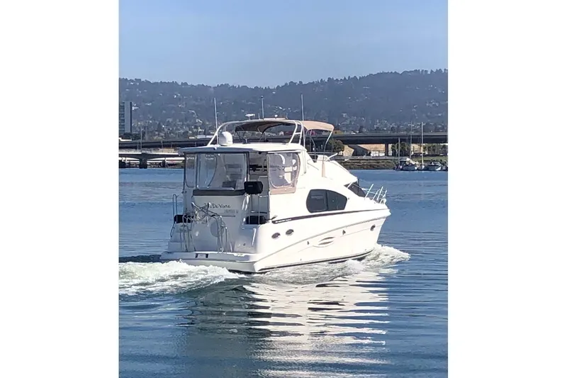 Slide: The Image of 2003 Silverton 35 Motor Yacht cruising on a calm lake with scenic mountain backdrop. - 20