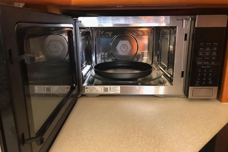 Slide: The Image of Open microwave oven on a 2003 Silverton 35 Motor Yacht kitchen counter. - 6