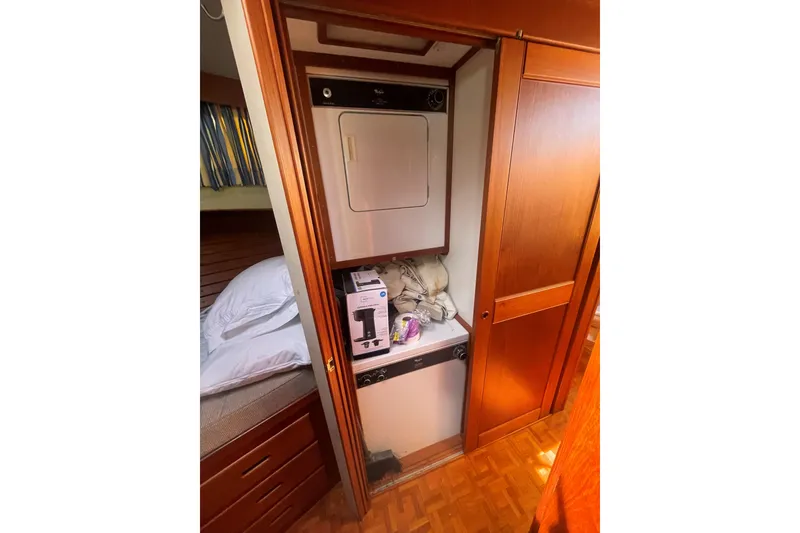 Slide: The Image of Laundry area inside 1990 Grand Banks 46 Classic yacht with wood paneling. - 14