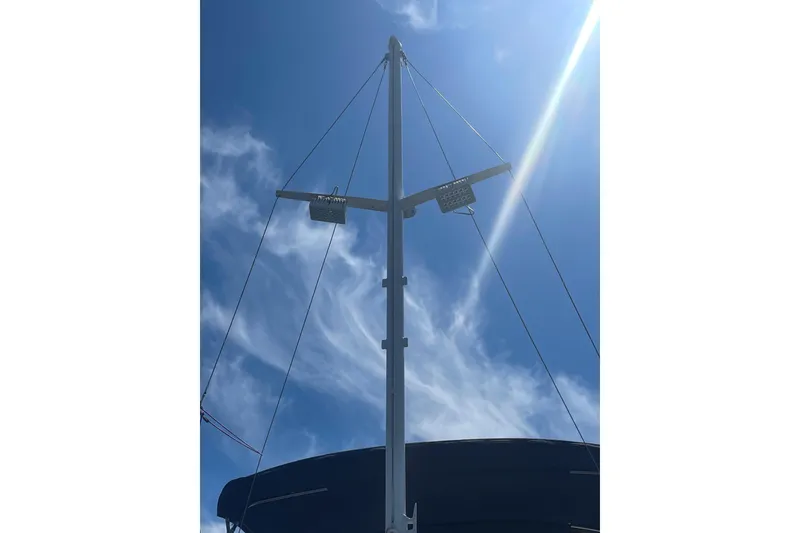 Slide: The Image of Mast of 1990 Grand Banks 46 Classic yacht against a bright blue sky. - 16