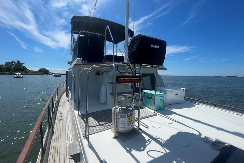 Slide: The Image of 1990 Grand Banks 46 Classic yacht on calm water under a clear blue sky. - 18