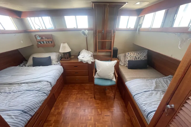 Slide: The Image of Cozy cabin interior of 1990 Grand Banks 46 Classic yacht with twin beds and wooden furnishings. - 19