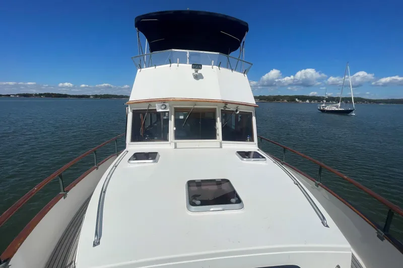 Slide: The Image of 1990 Grand Banks 46 Classic yacht on calm waters under a clear blue sky. - 4