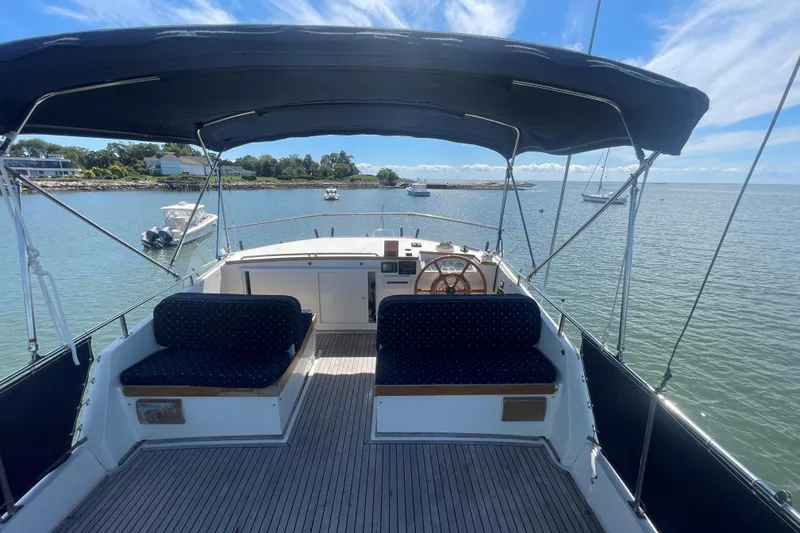 Slide: The Image of 1990 Grand Banks 46 Classic yacht with spacious deck and scenic water view. - 5