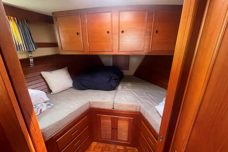 Slide: The Image of Cozy cabin interior of 1990 Grand Banks 46 Classic yacht with wooden cabinetry and twin beds. - 8