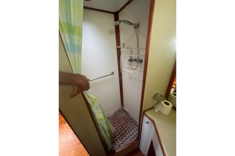 Slide: The Image of Shower area in 1990 Grand Banks 46 Classic yacht with curtain and wooden floor. - 9