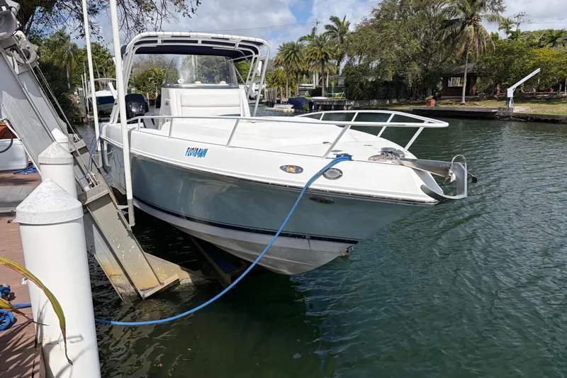 The Image of 2008 Donzi 29 ZF Cuddy boat docked on a sunny day. - 0