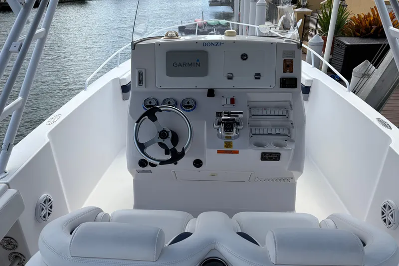 Slide: The Image of 2008 Donzi 29 ZF Cuddy boat cockpit with steering wheel and Garmin navigation system. - 10