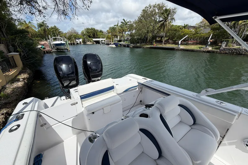 Slide: The Image of 2008 Donzi 29 ZF Cuddy boat with dual engines on a scenic waterway. - 13