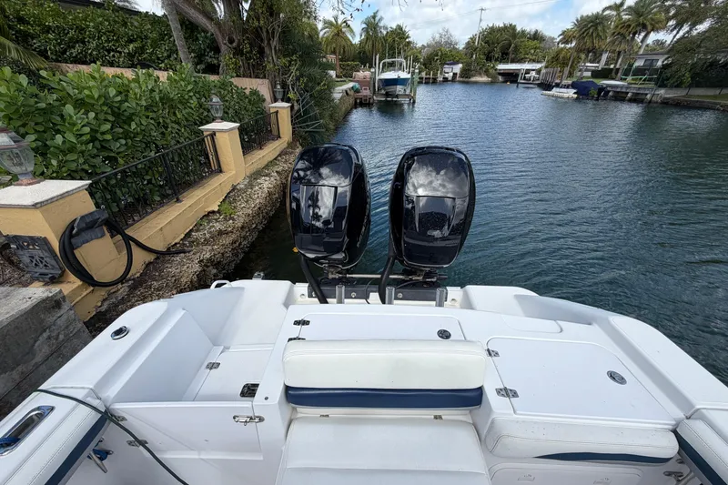Slide: The Image of 2008 Donzi 29 ZF Cuddy boat with dual engines docked in a scenic canal. - 14