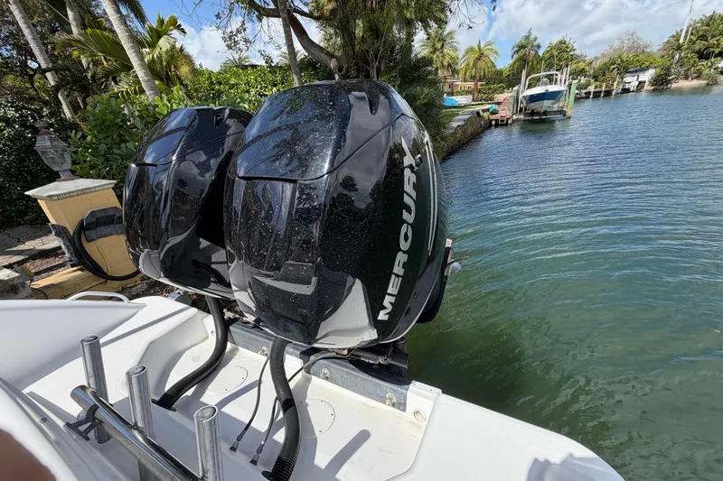 Slide: The Image of Twin Mercury outboard engines on a 2008 Donzi 29 ZF Cuddy boat by a scenic canal. - 16