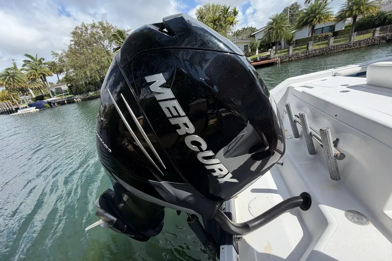 Slide: The Image of 2008 Donzi 29 ZF Cuddy with Mercury outboard engine on a sunny waterfront. - 17