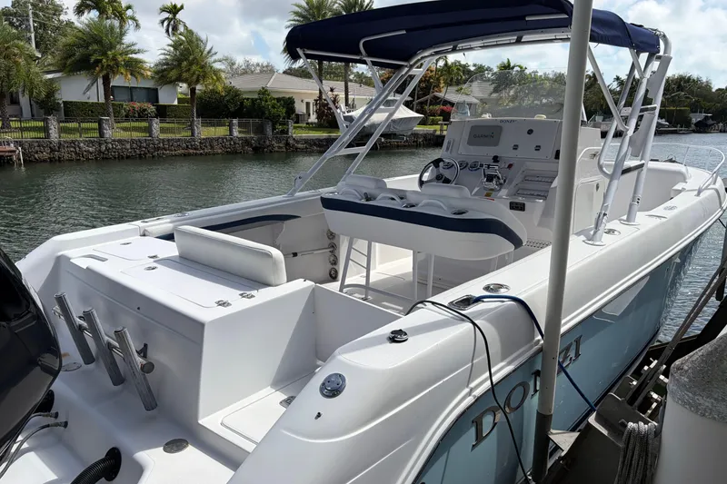 Slide: The Image of 2008 Donzi 29 ZF Cuddy boat docked by a canal, featuring sleek design and modern amenities. - 4