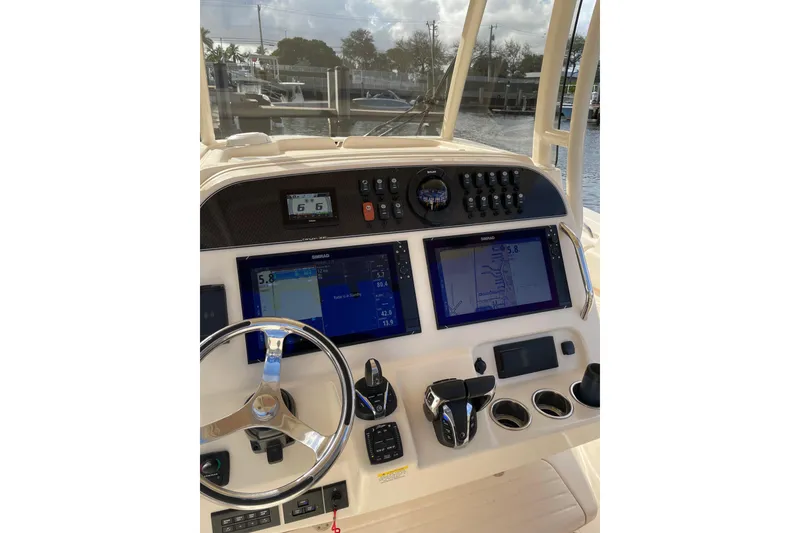 Slide: The Image of 2023 Grady-White Canyon 306 helm with advanced navigation displays and controls. - 10