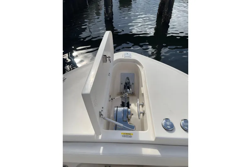Slide: The Image of 2023 Grady-White Canyon 306 boat anchor compartment, open lid, dockside view. - 15