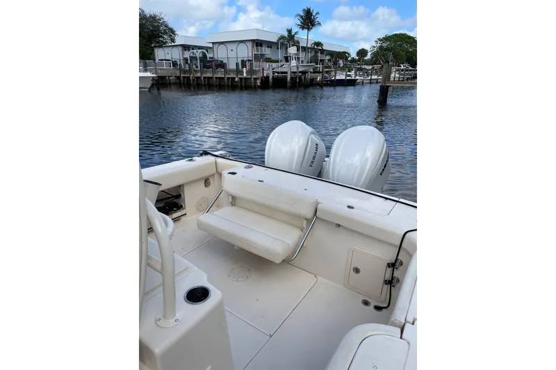 Slide: The Image of 2023 Grady-White Canyon 306 boat with twin Yamaha engines docked by the water. - 19