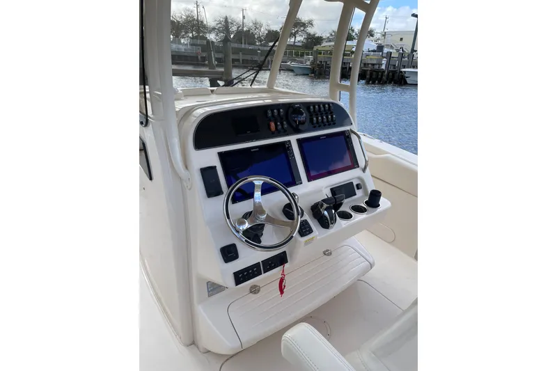Slide: The Image of 2023 Grady-White Canyon 306 boat helm with dual screens and steering wheel. - 8