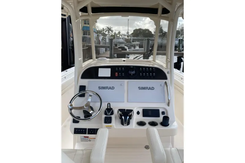 Slide: The Image of 2023 Grady-White Canyon 306 boat console with Simrad electronics and steering wheel. - 9