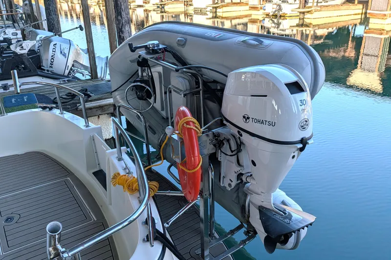 Slide: The Image of Nordic Tug 32 (2002) with Tohatsu outboard motor and inflatable boat at dock. - 10