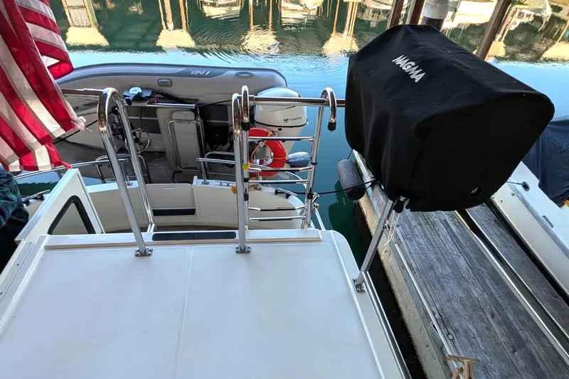 Slide: The Image of Nordic Tug 32 (2002) boat deck with American flag and covered grill. - 18