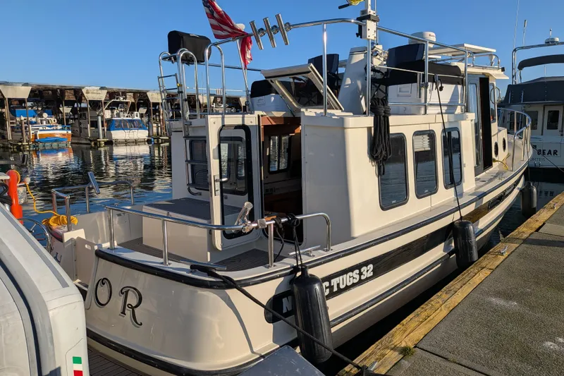 Slide: The Image of 2002 Nordic Tug 32 docked at marina, showcasing classic design and sturdy build. - 25