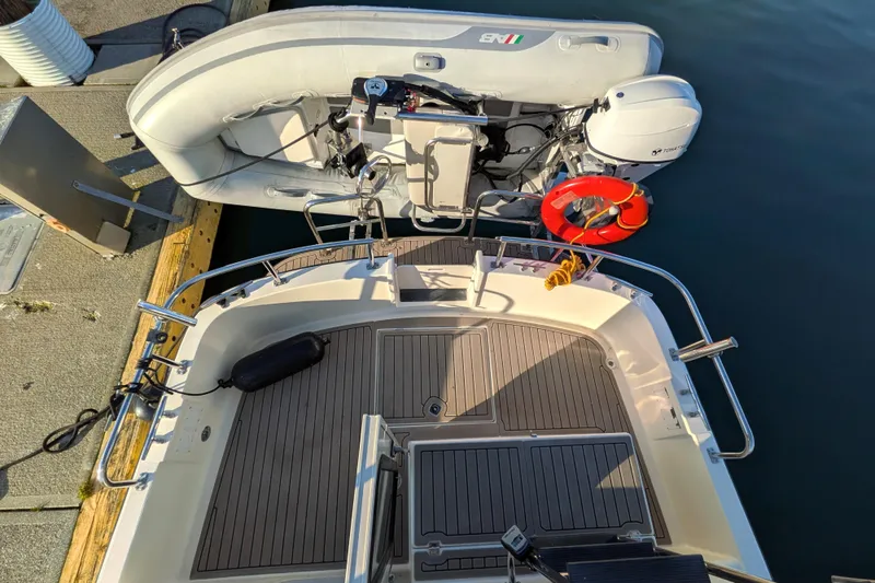Slide: The Image of Nordic Tug 32 (2002) docked with inflatable boat and life preserver on deck. - 29