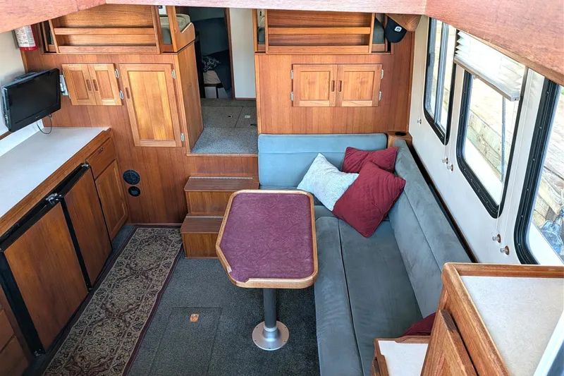 Slide: The Image of Cozy interior of 2002 Nordic Tug 32 with wood cabinetry and seating area. - 31