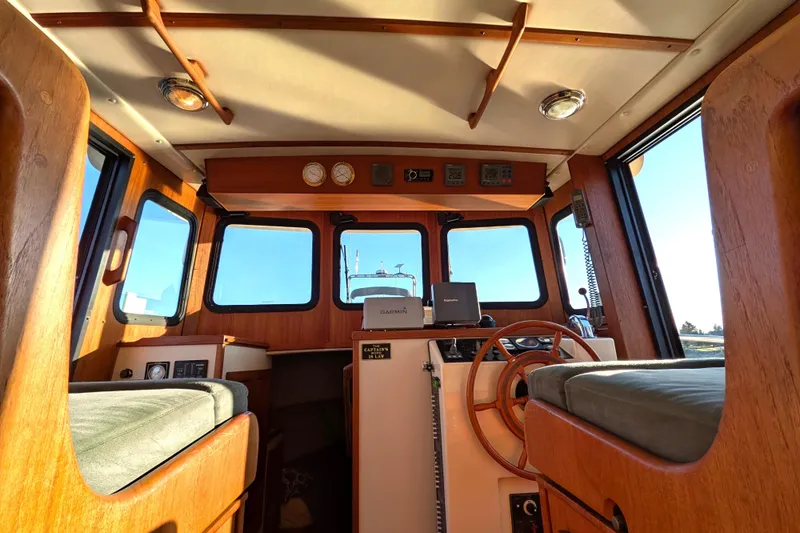 Slide: The Image of Pilothouse interior of 2002 Nordic Tug 32 with wooden accents and navigation equipment. - 44