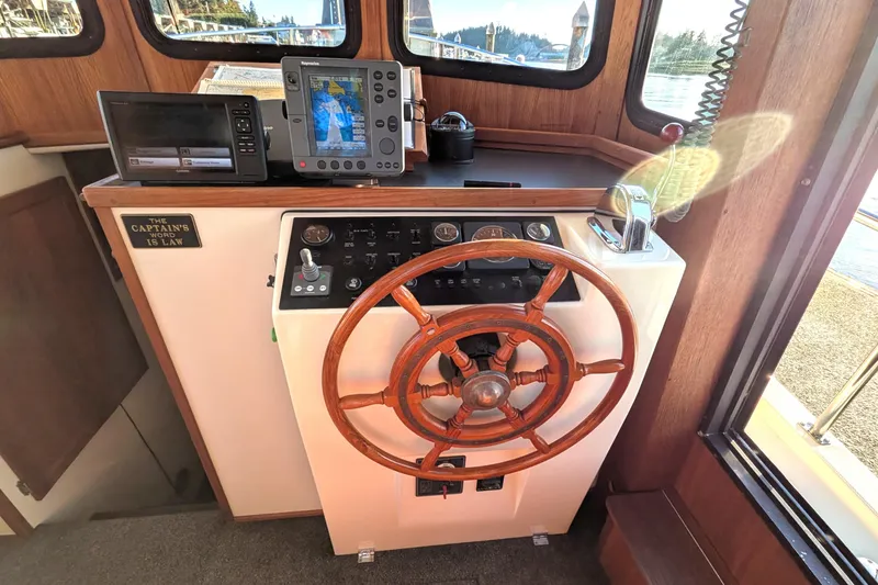Slide: The Image of Helm of 2002 Nordic Tug 32 with wooden wheel and navigation equipment. - 47