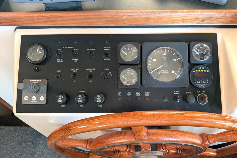 Slide: The Image of Control panel of a 2002 Nordic Tug 32 with wooden steering wheel. - 50