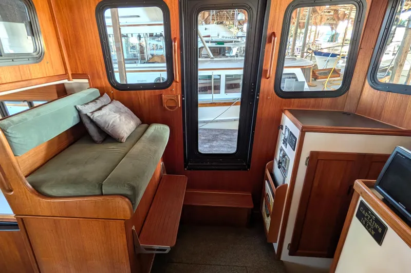 Slide: The Image of Cozy interior of 2002 Nordic Tug 32 with wooden finish and seating area. - 53