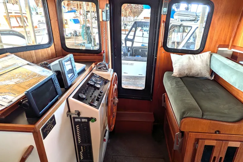 Slide: The Image of Cozy interior of 2002 Nordic Tug 32 with navigation equipment and seating area. - 55