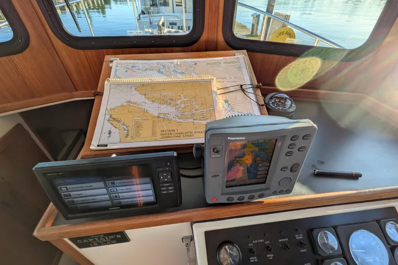 Slide: The Image of Navigation equipment on a 2002 Nordic Tug 32, featuring maps and electronic displays. - 59