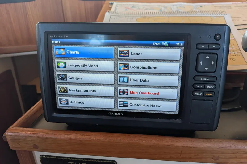 Slide: The Image of Garmin navigation system on 2002 Nordic Tug 32, displaying charts and settings menu. - 60