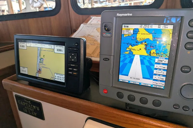Slide: The Image of Navigation equipment on a 2002 Nordic Tug 32, featuring Garmin and Raymarine displays. - 62