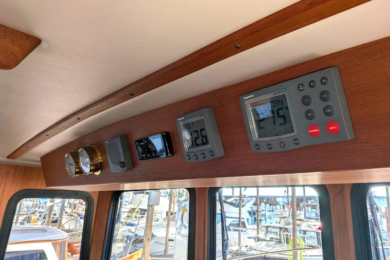 Slide: The Image of Control panel of a 2002 Nordic Tug 32 with navigation instruments and gauges. - 65