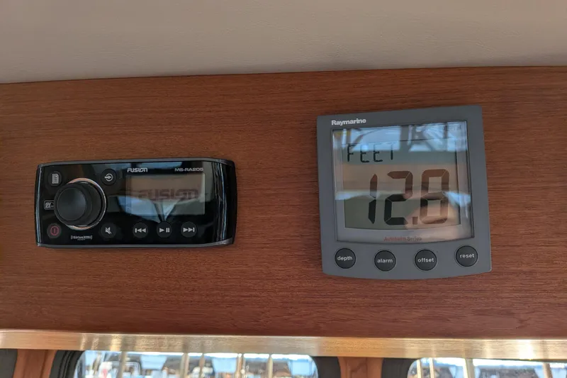 Slide: The Image of Control panel on a 2002 Nordic Tug 32, featuring Fusion and Raymarine displays. - 66