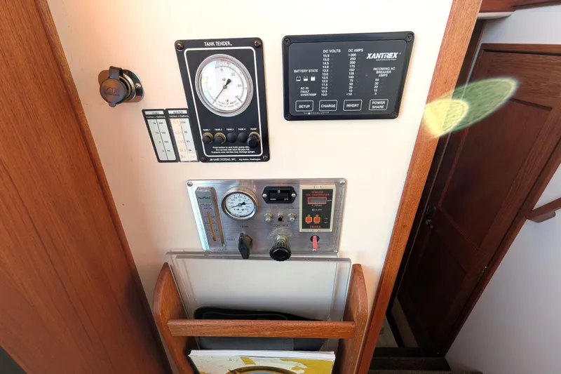 Slide: The Image of Control panel of a 2002 Nordic Tug 32 with gauges and switches. - 69