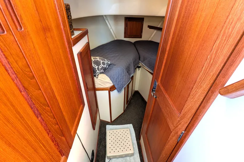 Slide: The Image of Cozy cabin interior of 2002 Nordic Tug 32 with wooden finishes and twin beds. - 72