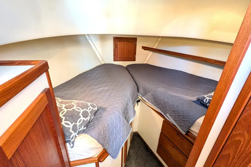 Slide: The Image of Cozy cabin interior of 2002 Nordic Tug 32 with twin beds and wooden accents. - 73