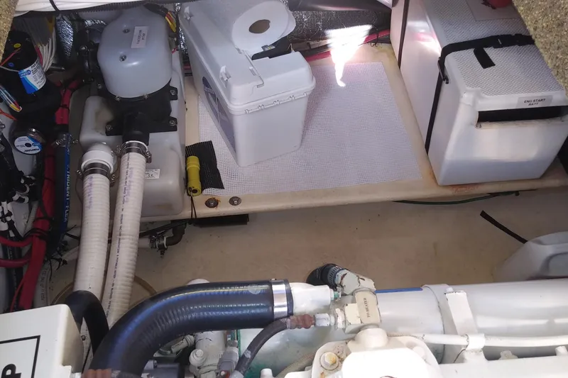 Slide: The Image of Engine room of a 2002 Nordic Tug 32, featuring hoses and storage compartments. - 77