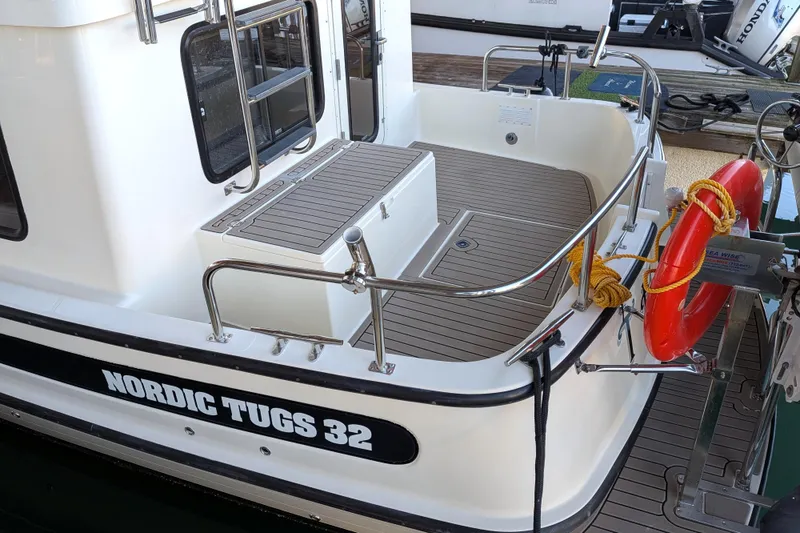 Slide: The Image of 2002 Nordic Tug 32 boat deck with safety equipment and railing. - 9