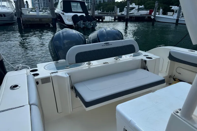 Slide: The Image of 2018 Cobia 301 Center Console boat with dual engines docked at marina. - 18